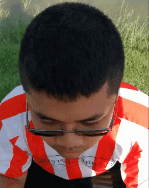 a man wearing glasses and a shirt that says ' thailand ' on the front