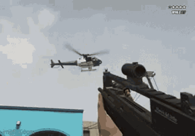 a person is holding a sniper rifle in a video game in a city .