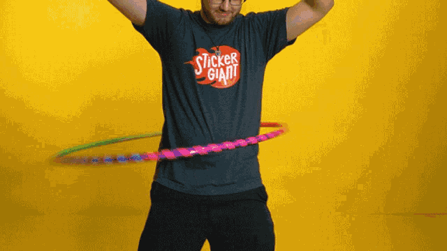 a man wearing a shirt that says sticker giant hula hoops