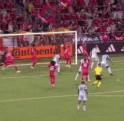 a soccer game is being played on a field with a continental sign in the background