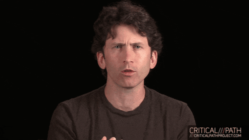 a man in a black shirt is talking in front of a black background that says critical path project.com