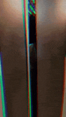 a blurry picture of a person 's torso with a rainbow of colors
