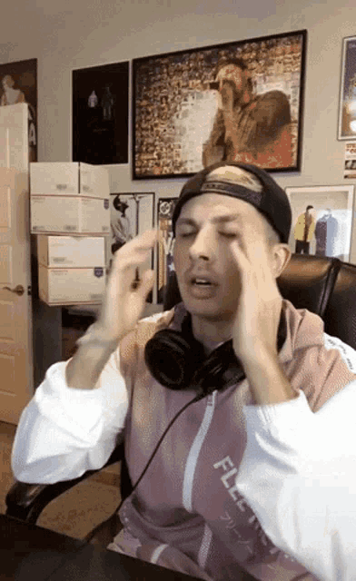 a man wearing headphones and a jacket that says ' flex ' on it