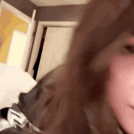 a blurred image of a person 's face with a door in the background