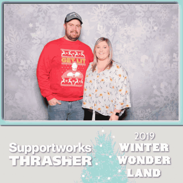 a man in a red sweater stands next to a woman in a white floral shirt