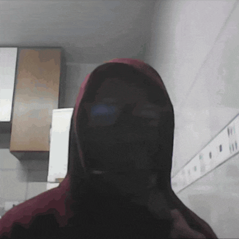 a person in a red hoodie with a hood on their head