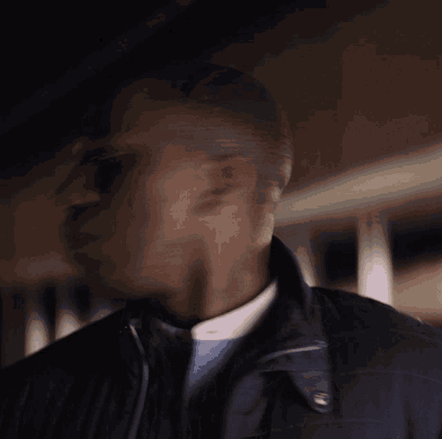a blurry picture of a man 's face with his eyes closed