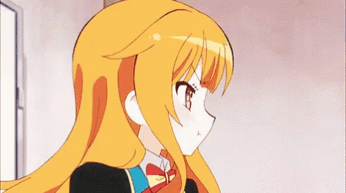 a girl with long orange hair and a bow tie is standing in a room .