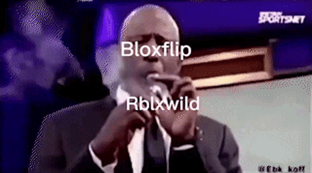 a man in a suit and tie with the words bloxflip rblxwild on the bottom