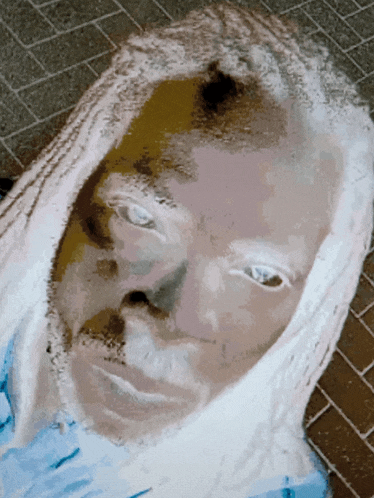 a close up of a person 's face with white eyes and a blue shirt