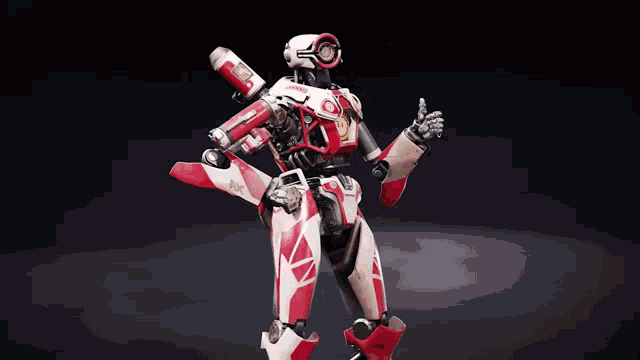 a red and white robot is standing upright on a dark surface .