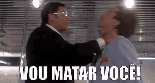 a man in a suit is holding another man 's neck and says `` vou matar você '' .
