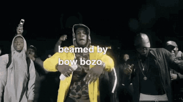 a man in a yellow jacket is being beamed by bow bozo in a video