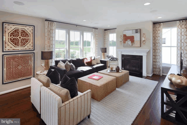 a living room with a fireplace and a bright mls logo on the bottom