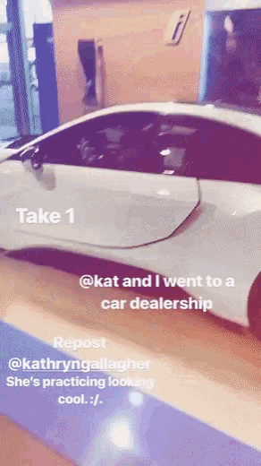 a white car is on display in a car dealership with the caption take 1
