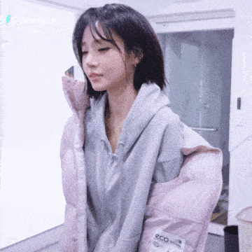 a woman wearing a pink jacket that says eco on the front