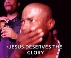 a bald man is covering his mouth with his hand and the words `` jesus deserves the glory '' are behind him .
