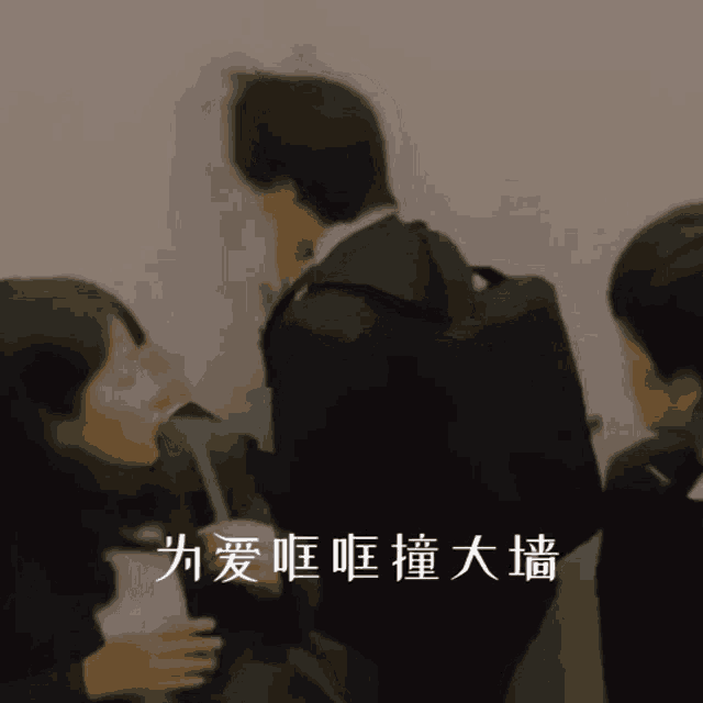 a man in a suit is standing next to a woman with chinese writing on the bottom