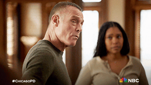 a man and a woman are standing next to each other with a chicagopd logo in the corner