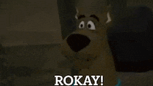 a cartoon scooby doo says rokay in front of a dark background