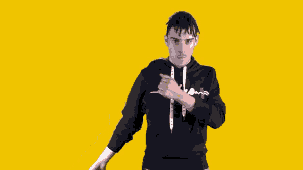 a man wearing a black hoodie with a cross on the sleeve