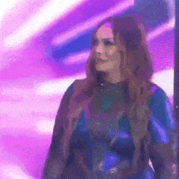 a woman in a blue dress is standing in front of a purple background