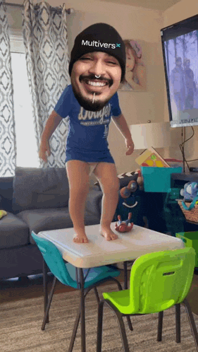 a child wearing a blue shirt that says ' dodge ' on it is jumping on a table