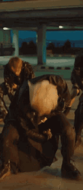 a man in a leather jacket and black pants is dancing in a crowd of people .