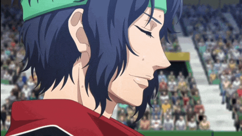 a man with blue hair and a green headband is smiling