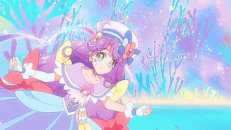 a girl with purple hair and a flower in her hair is smiling in front of a coral reef .