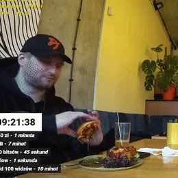 a man sitting at a table with a plate of food and a timer that reads 9:22 20:38