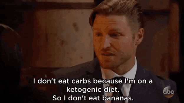 a man in a suit and tie is saying that he does n't eat carbs because he is on a ketogenic diet