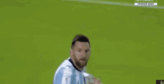 a man in a soccer uniform is running on a field .