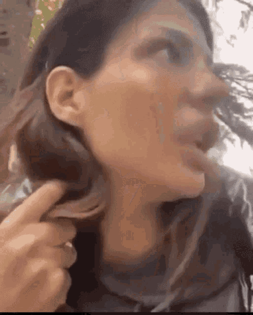 a close up of a woman 's face with her mouth open .
