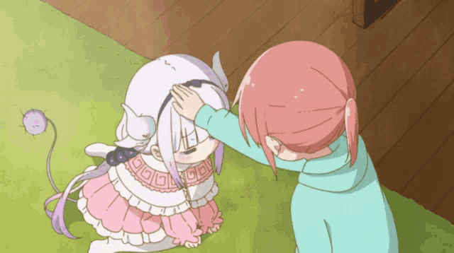 a girl petting another girl 's head with a purple tail