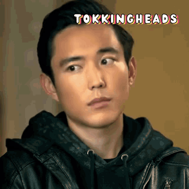 a close up of a man 's face with the words " tokingheads " behind him