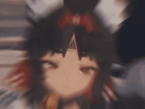 a blurry picture of a anime girl with a red bow on her head