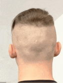 the back of a man 's head with a shaved head and a shaved neck .