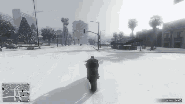 a person riding a motorcycle on a snowy street in front of a sign that says ' rod robert hills '