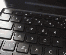 a close up of a keyboard with the letters z y x and c visible