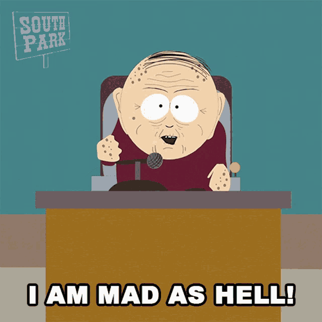 a south park character sitting at a desk with a microphone and the words i am mad as hell