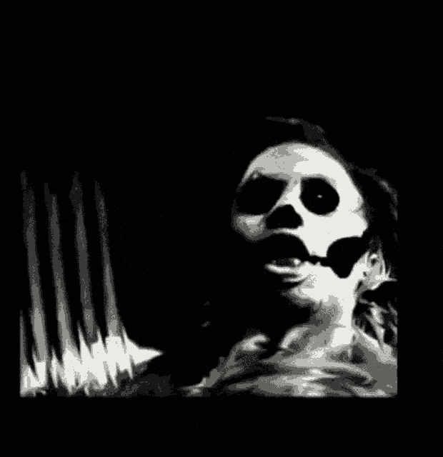 a black and white painting of a skull with black spots on it 's face .