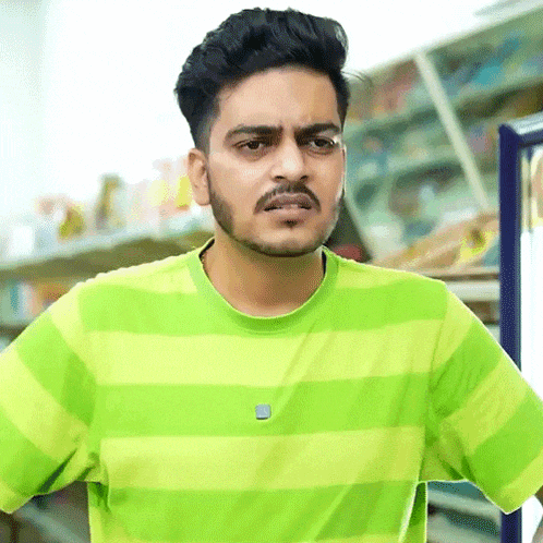 a man with a beard is wearing a green and white striped shirt .