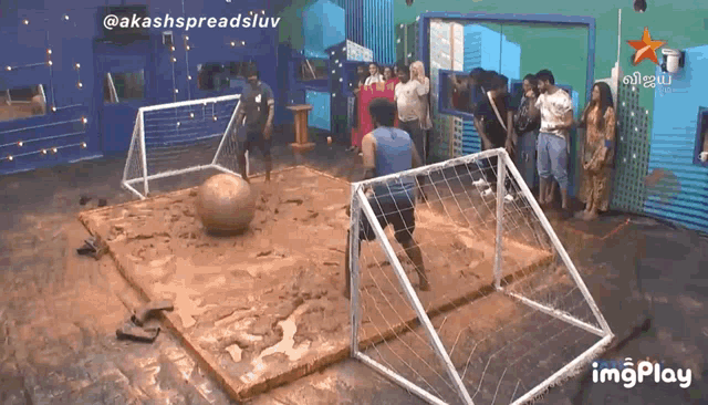 a group of people are playing a game of soccer in a room that says imgplay at the bottom