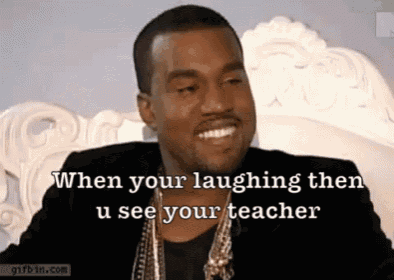 a man with a beard is laughing while wearing a black jacket and gold necklace .