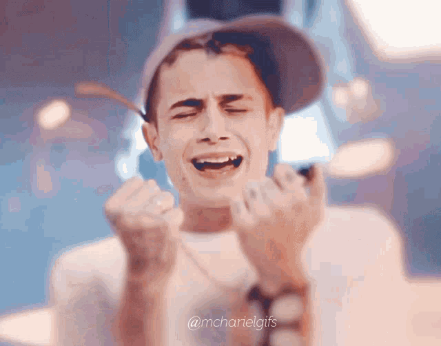 a close up of a man making a funny face with the words @mcharielgifs below him