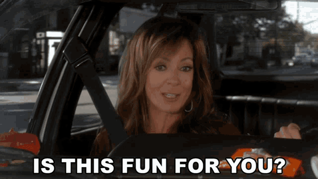 a woman driving a car with the words is this fun for you