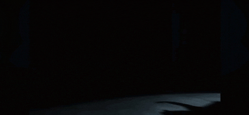 a blurry picture of a group of people standing in a dark room