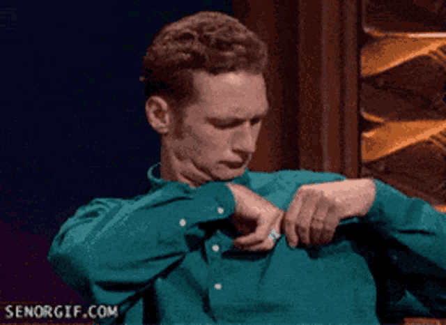 a man in a green shirt has senorgif.com written on the bottom of his shirt