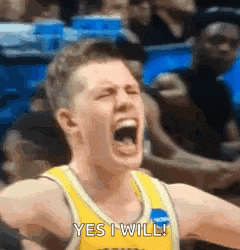 a basketball player is screaming and saying yes i will during a game .